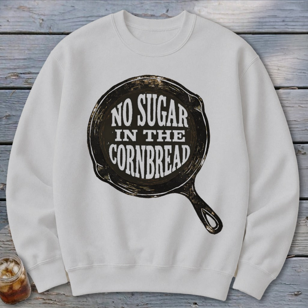 White sweatshirt with a graphic of a cast iron skillet saying "No Sugar in the Cornbread".