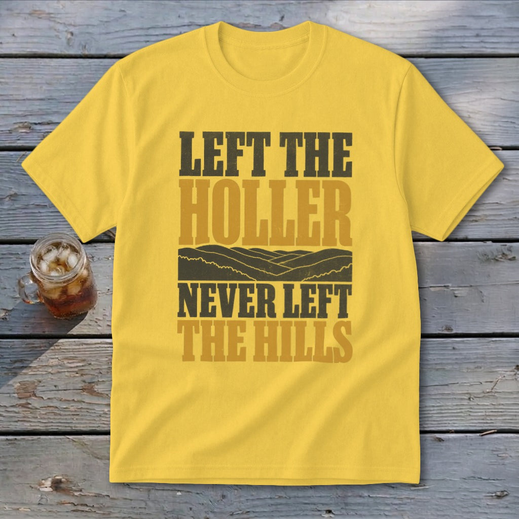 Yellow t-shirt with text "LEFT THE HOLLER NEVER LEFT THE HILLS" and mountain graphics.