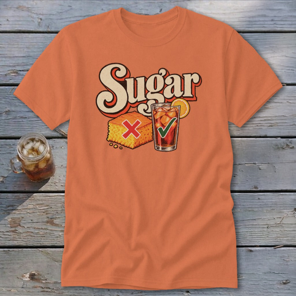 An orange t-shirt featuring the word Sugar above an illustration of cornbread with a red X and sweet tea with a green checkmark.