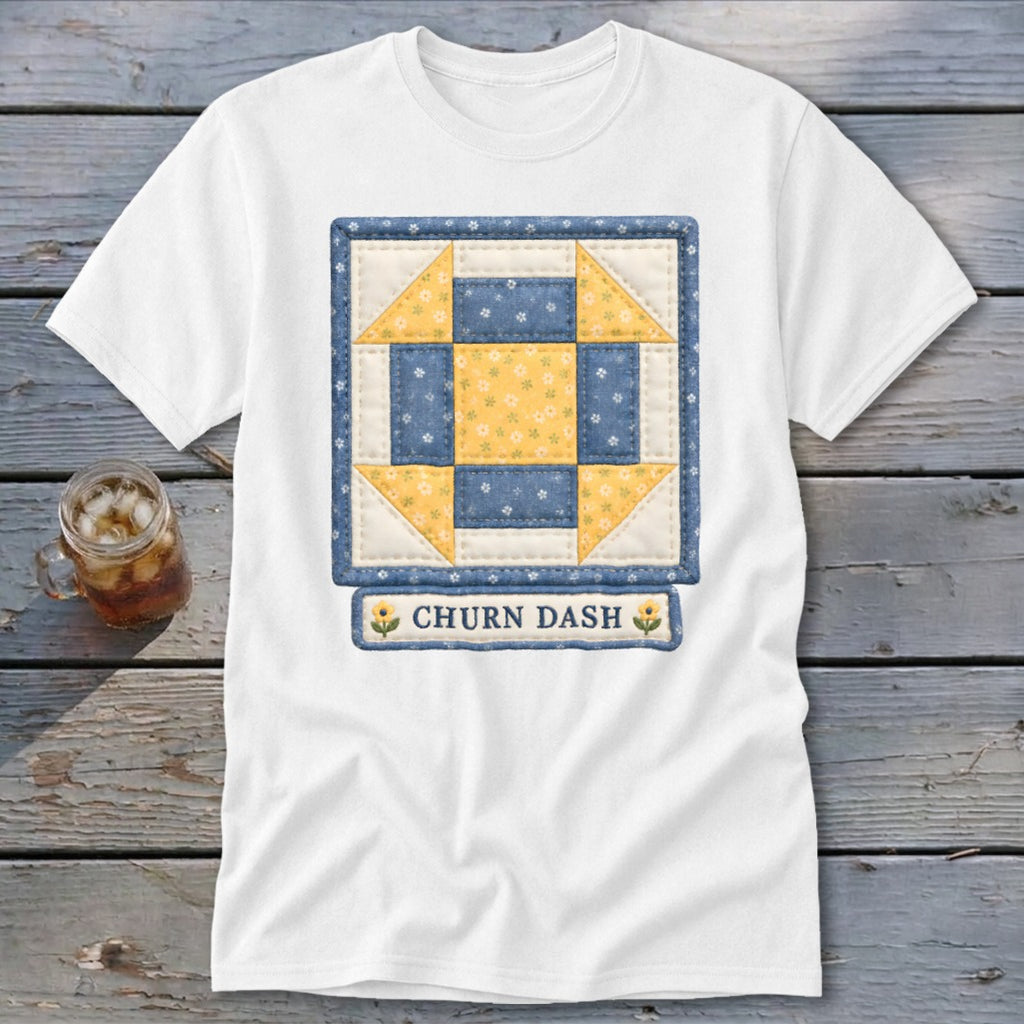 White t-shirt with a blue and yellow "Churn Dash" quilt block design.