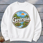 White sweatshirt featuring a circular graphic with "Georgia" and a scenic mountain landscape.