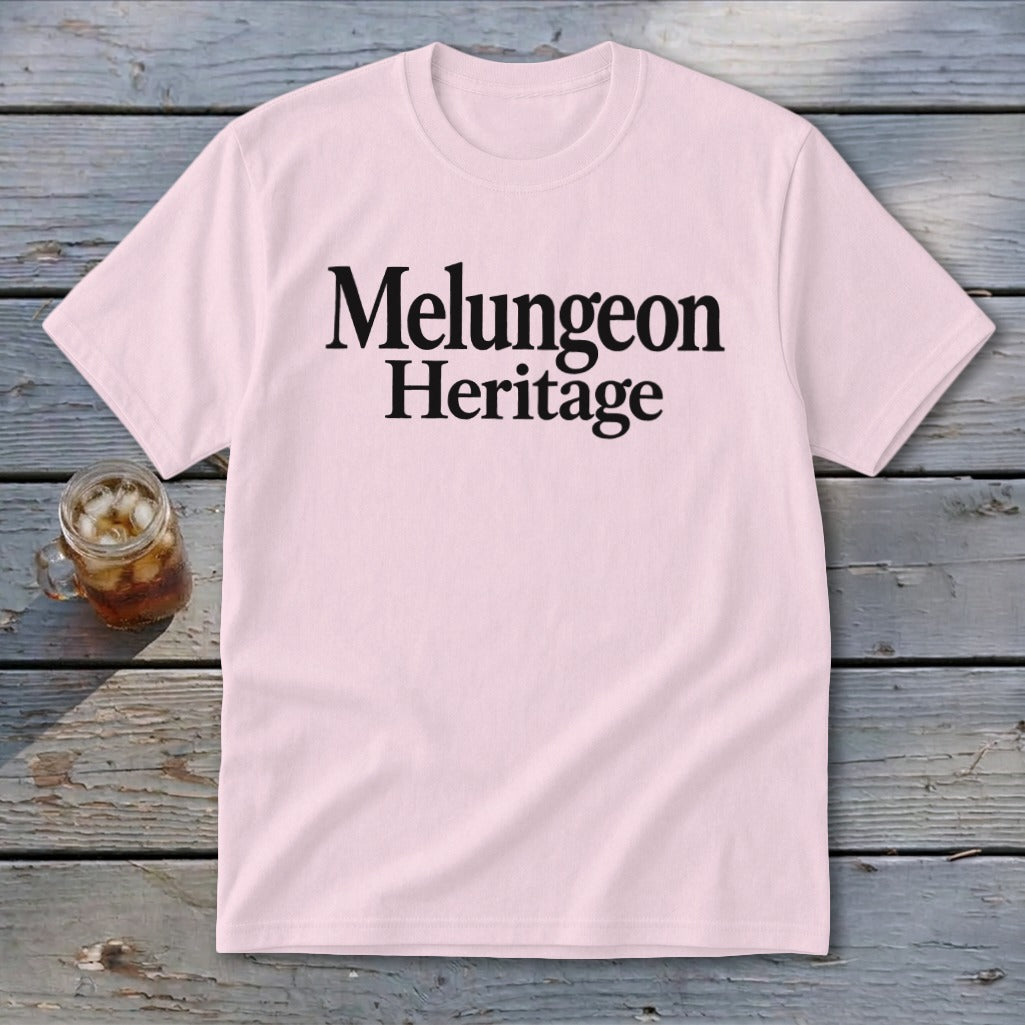 A light pink short-sleeve t-shirt with the black text Melungeon Heritage displayed on the chest.