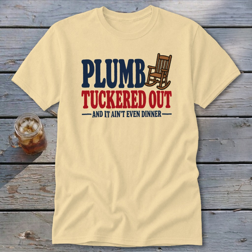 Light yellow t-shirt with "PLUMBER TUCKERED OUT AND IT AIN'T EVEN DINNER" text and rocking chair graphic.