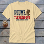 Light yellow t-shirt with "PLUMBER TUCKERED OUT AND IT AIN'T EVEN DINNER" text and rocking chair graphic.
