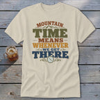 Cream t-shirt with "Mountain Time Means Whenever We Get There" graphic and clock.