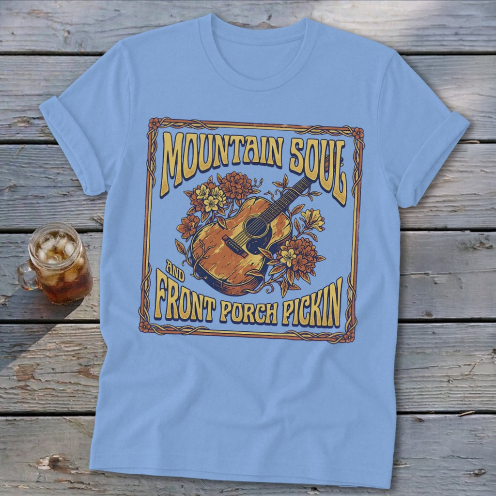 Light blue t-shirt with "Mountain Soul and Front Porch Pickin'" text and acoustic guitar graphic.