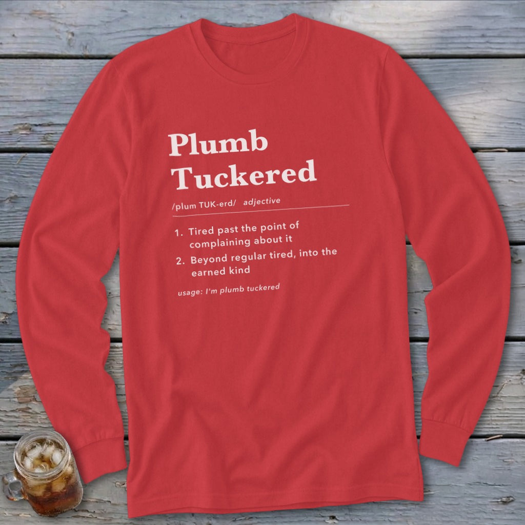 Red long-sleeve shirt with "Plumb Tuckered" definition printed in white.