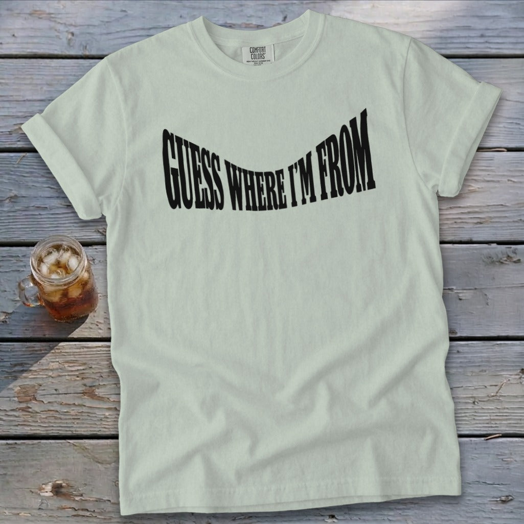 Pale green t-shirt with black text that says "GUESS WHERE I'M FROM".
