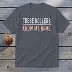 Gray t-shirt with "THESE HOLLERS KNOW MY NAME" text in white and pink.