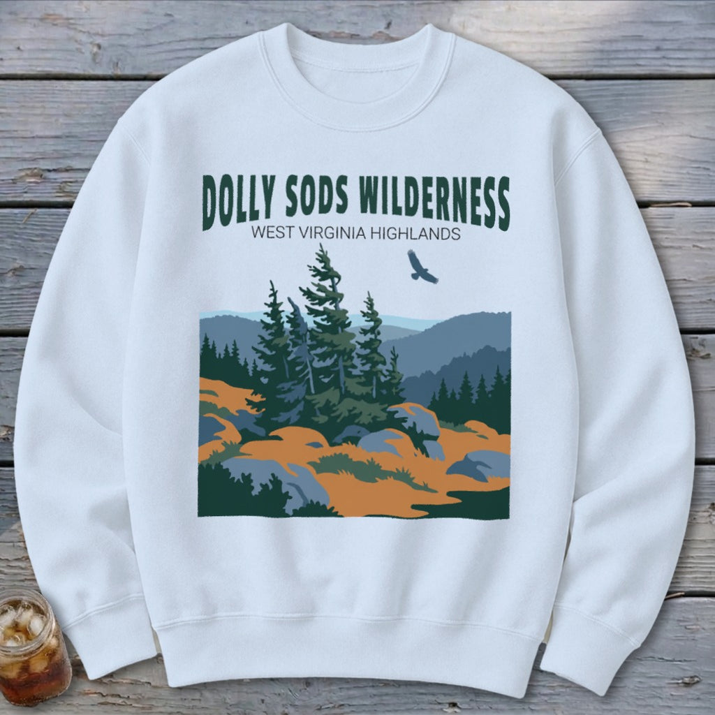 A white crewneck sweatshirt featuring a graphic of the Dolly Sods Wilderness with evergreen trees and mountains.