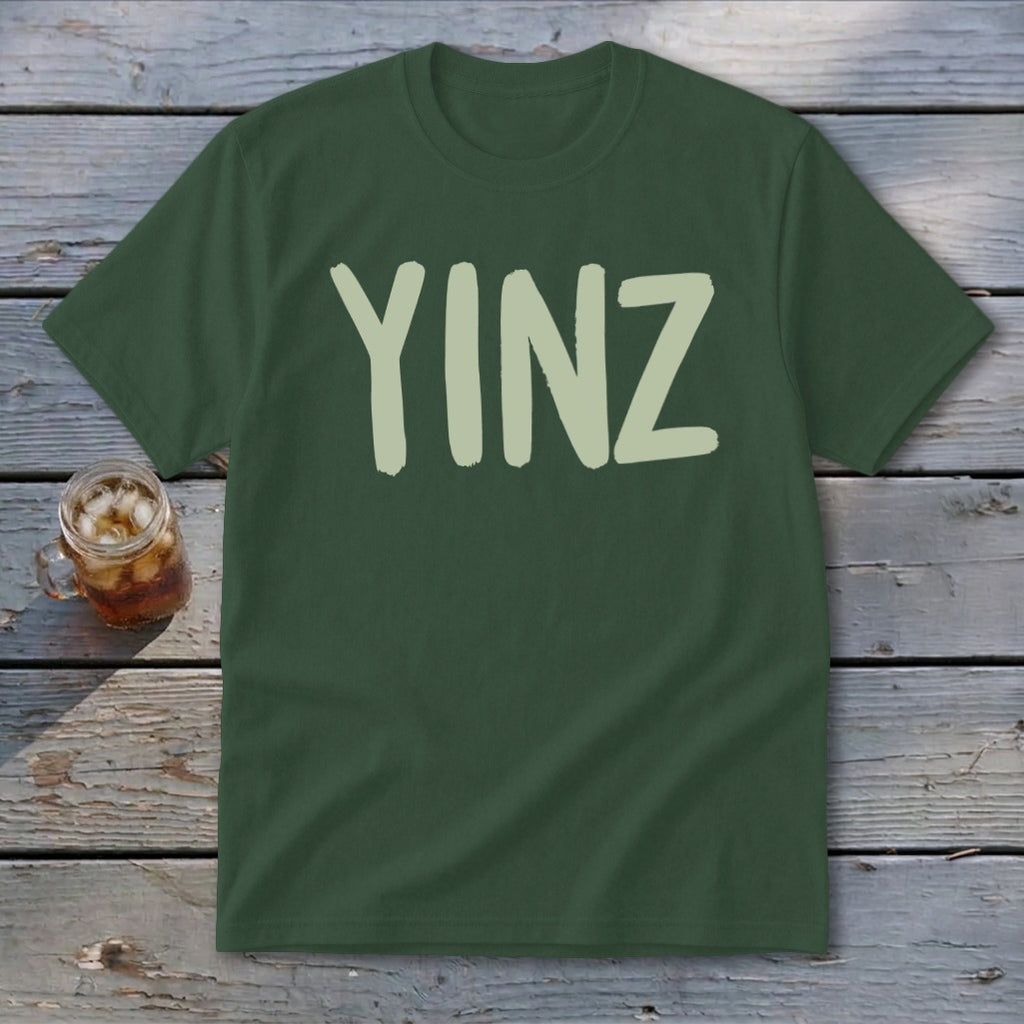 Dark green t-shirt with light green "YINZ" text and a glass of iced beverage.
