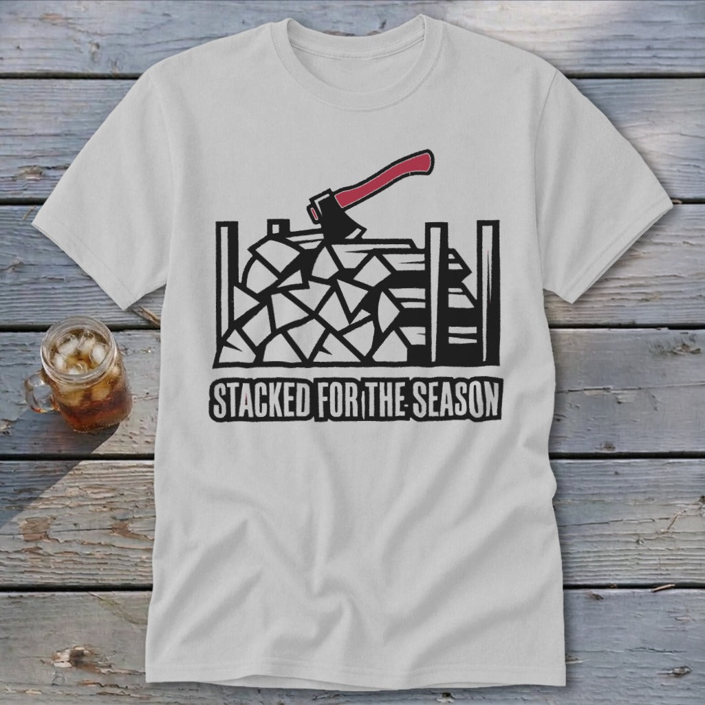 White t-shirt with graphic of chopped wood, axe, and text "STACKED FOR THE SEASON".