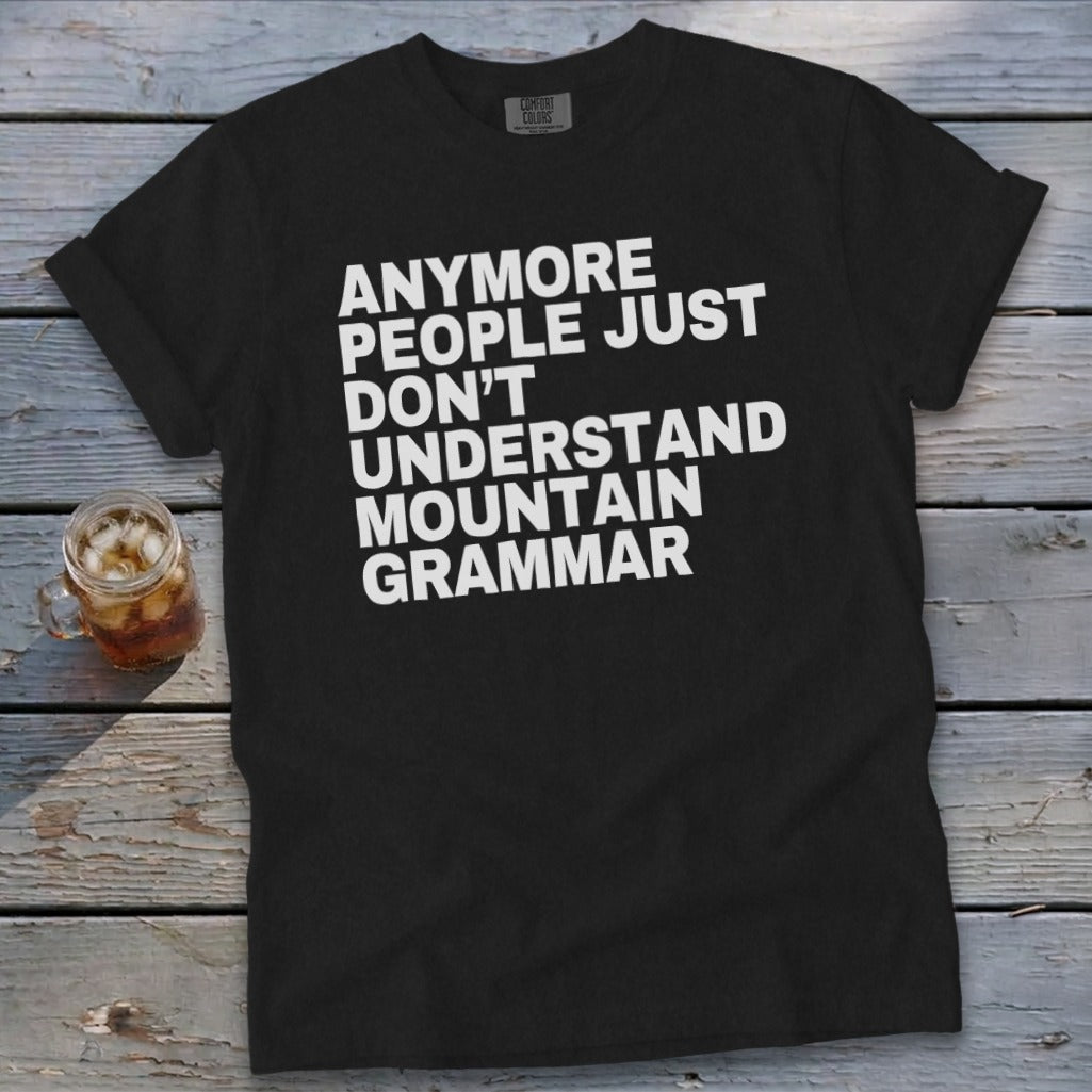 Black t-shirt with white text: "Anymore people just don't understand mountain grammar."