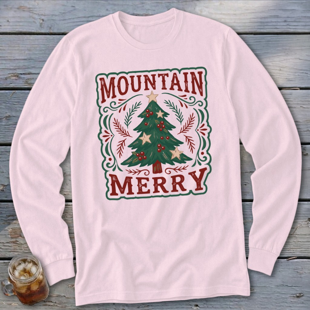 Light pink long-sleeve shirt with a festive Christmas tree graphic and the text Mountain Merry.