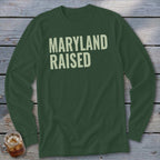 Dark green long-sleeve shirt with "MARYLAND RAISED" in light cream text.