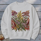 White crewneck sweatshirt featuring a colorful floral and foliage print with autumn colors.