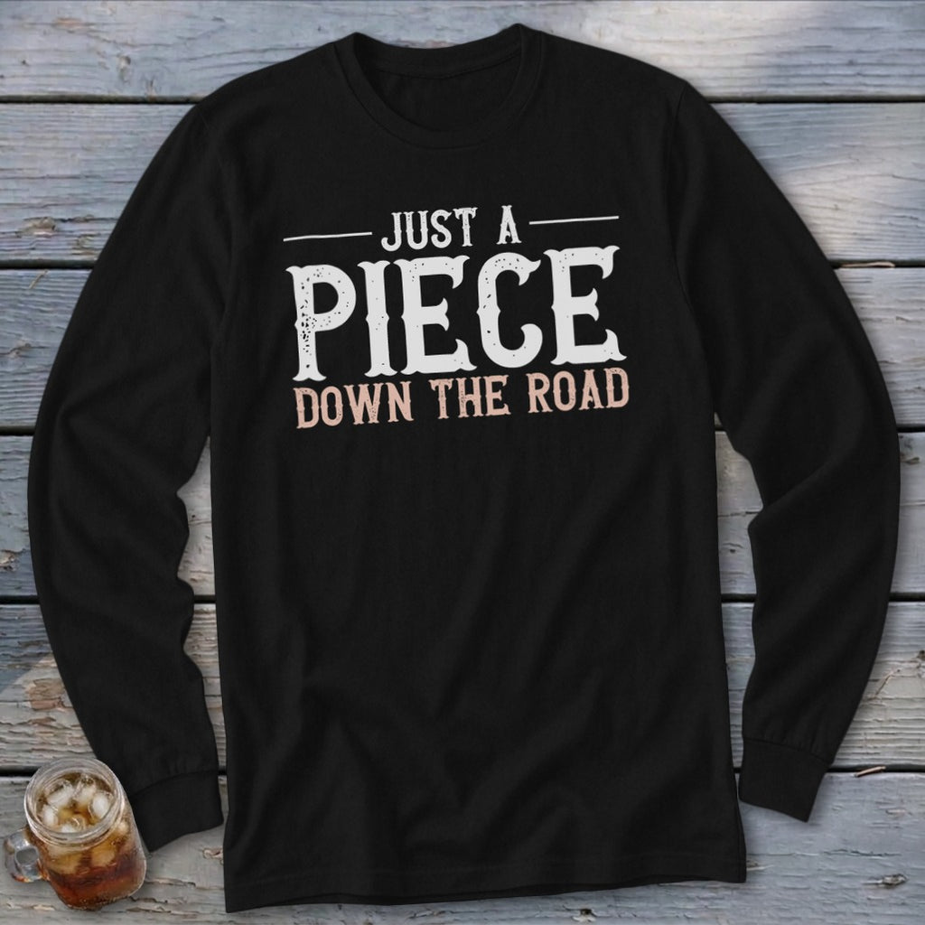 Black long sleeve shirt with "Just a Piece Down the Road" text graphic.