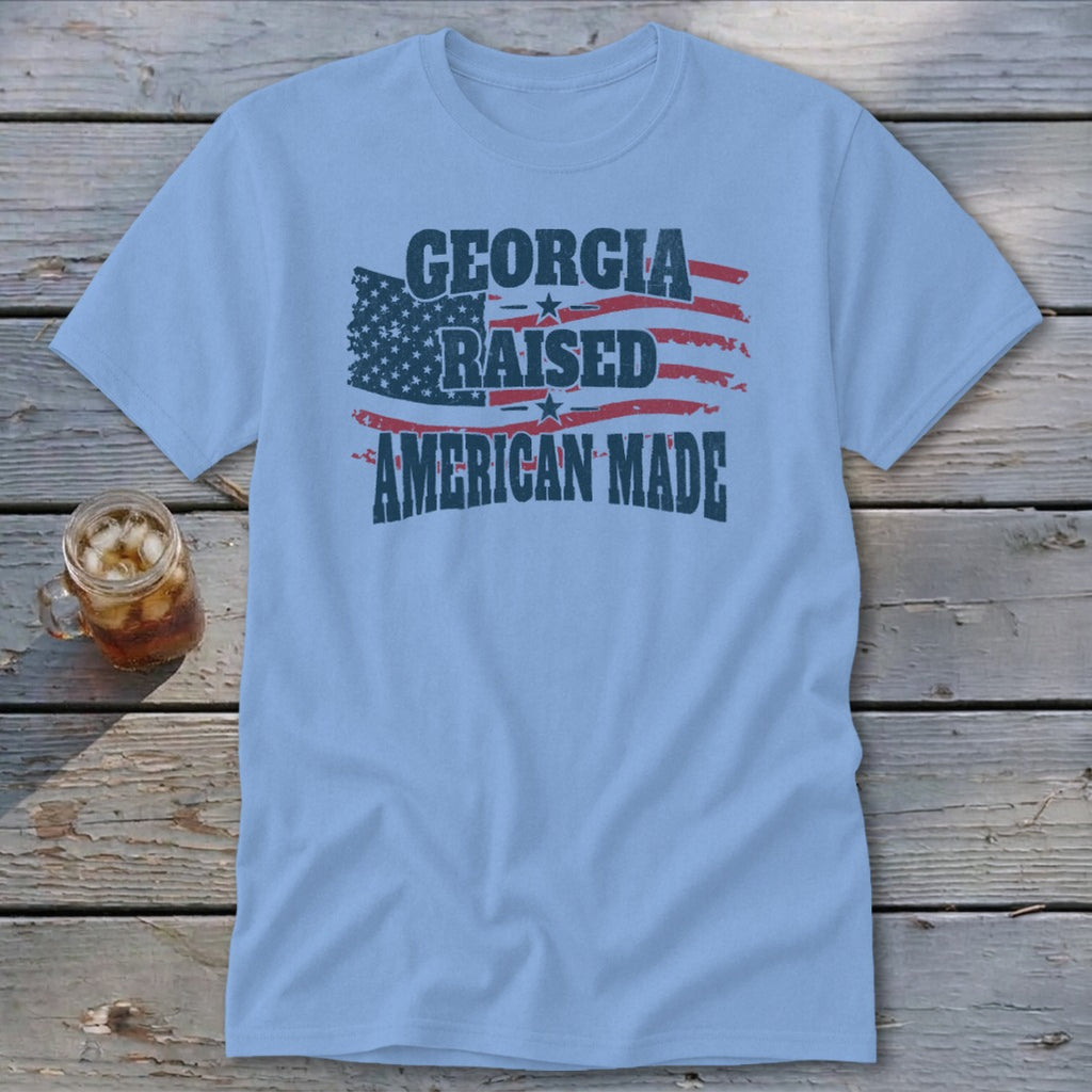 Light blue crewneck t-shirt featuring a distressed American flag graphic with the text Georgia Raised American Made.