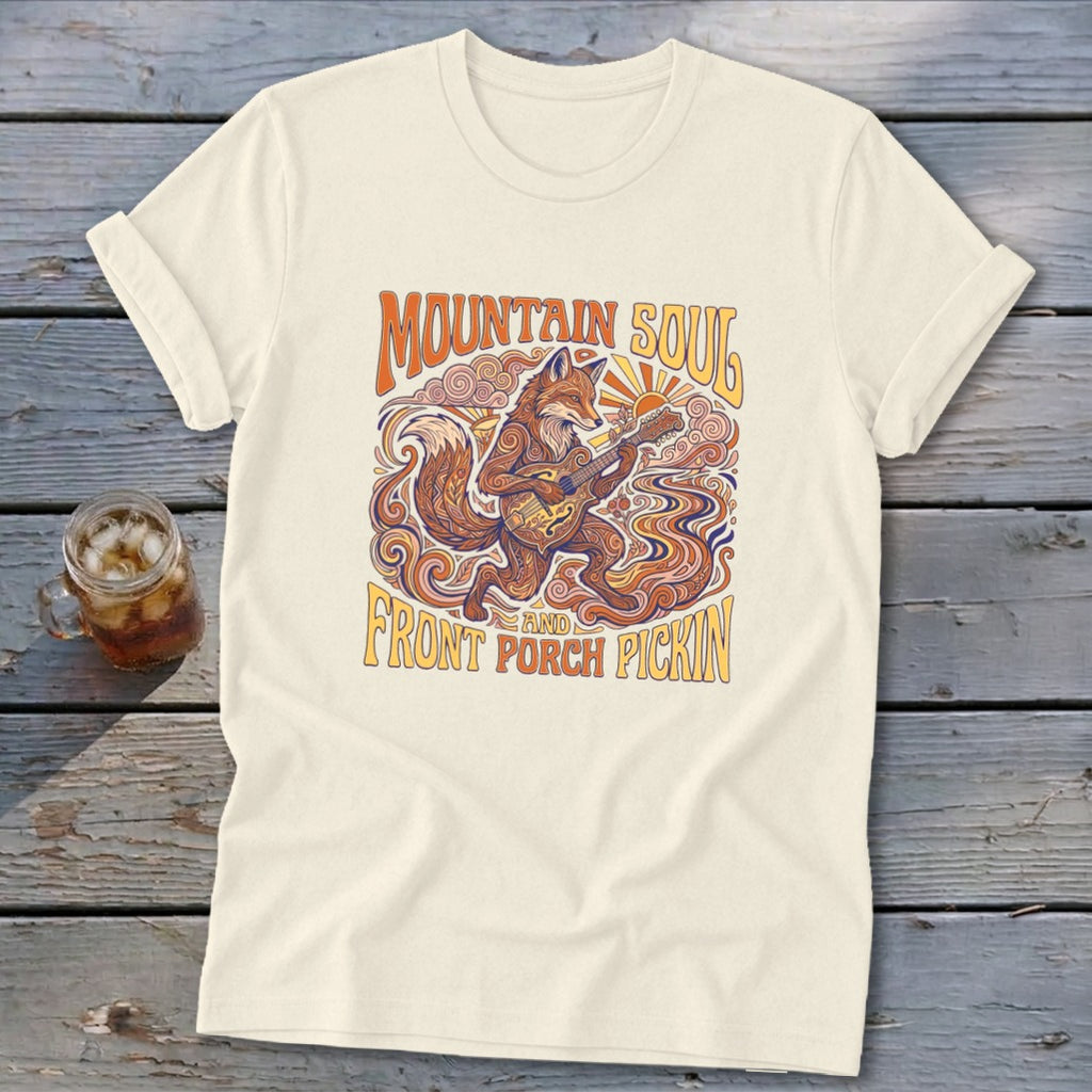 Cream t-shirt with graphic of a fox playing a guitar with text "Mountain Soul and Front Porch Pickin'".