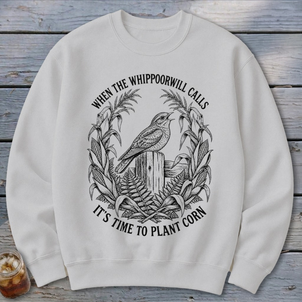 Off-white crewneck sweatshirt featuring a black graphic of a bird on a post surrounded by corn with text.