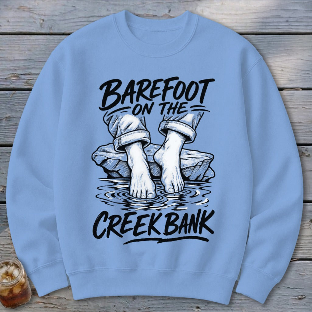 Light blue sweatshirt with "Barefoot on the Creek Bank" graphic.