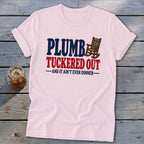 Pink t-shirt with "PLUMB TUCKERED OUT AND IT AIN'T EVEN DINNER" text and rocking chair.
