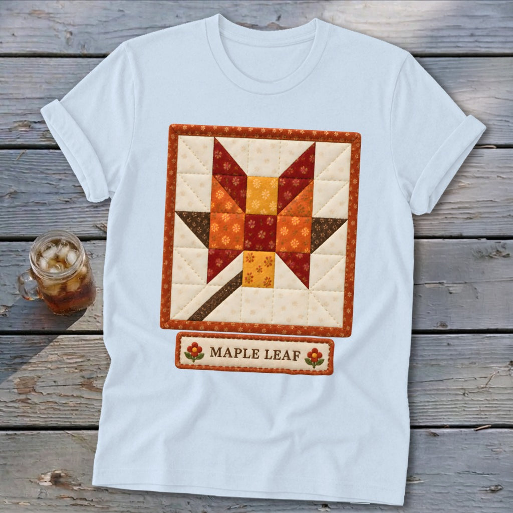White t-shirt with a quilted maple leaf design and "MAPLE LEAF" text.