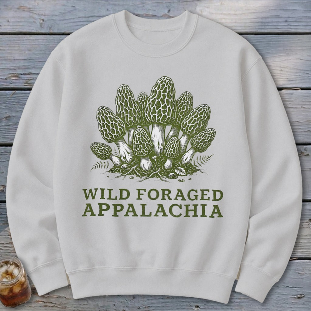 White sweatshirt with green illustration of morel mushrooms and text "WILD FORAGED APPALACHIA".