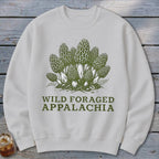 White sweatshirt with green illustration of morel mushrooms and text "WILD FORAGED APPALACHIA".