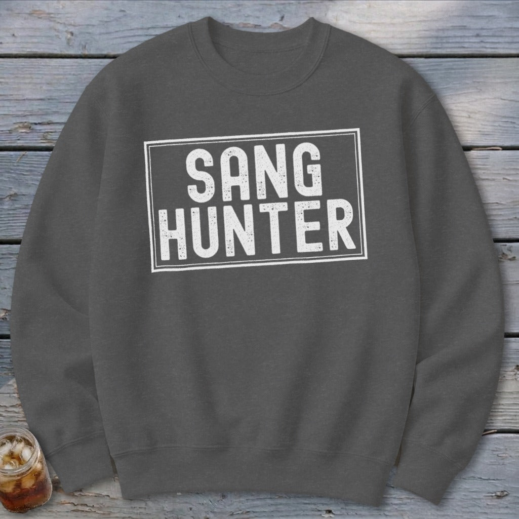 Dark grey sweatshirt with white text inside a rectangle reading "SANG HUNTER".