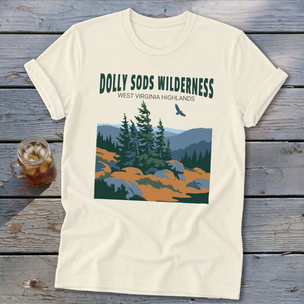 Cream-colored t-shirt with a graphic of the Dolly Sods Wilderness landscape featuring pine trees and text.