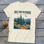 Cream-colored t-shirt with a graphic of the Dolly Sods Wilderness landscape featuring pine trees and text.