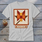 White t-shirt with a quilted maple leaf block design and "MAPLE LEAF" text.