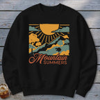 Black sweatshirt with "Mountain Summers" graphic featuring a sun, mountains, and clouds.