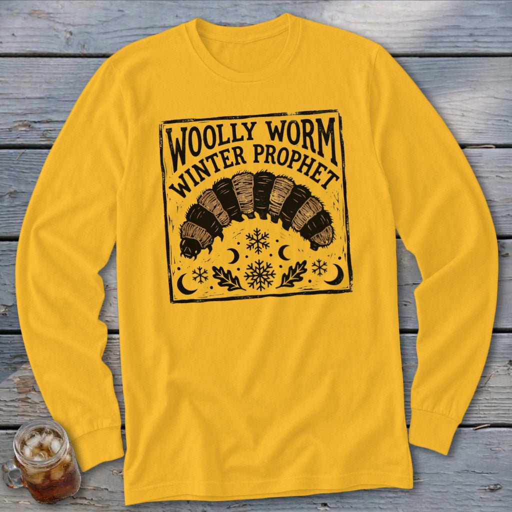 Gold long-sleeved t-shirt featuring a black block-print design of a woolly worm, snowflakes, and the text Woolly Worm Winter Prophet.