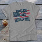 Gray t-shirt with "Holler Raised American Made" text and distressed American flag graphic.