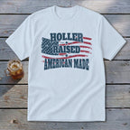 White t-shirt with distressed American flag graphic and text "Holler Raised American Made".