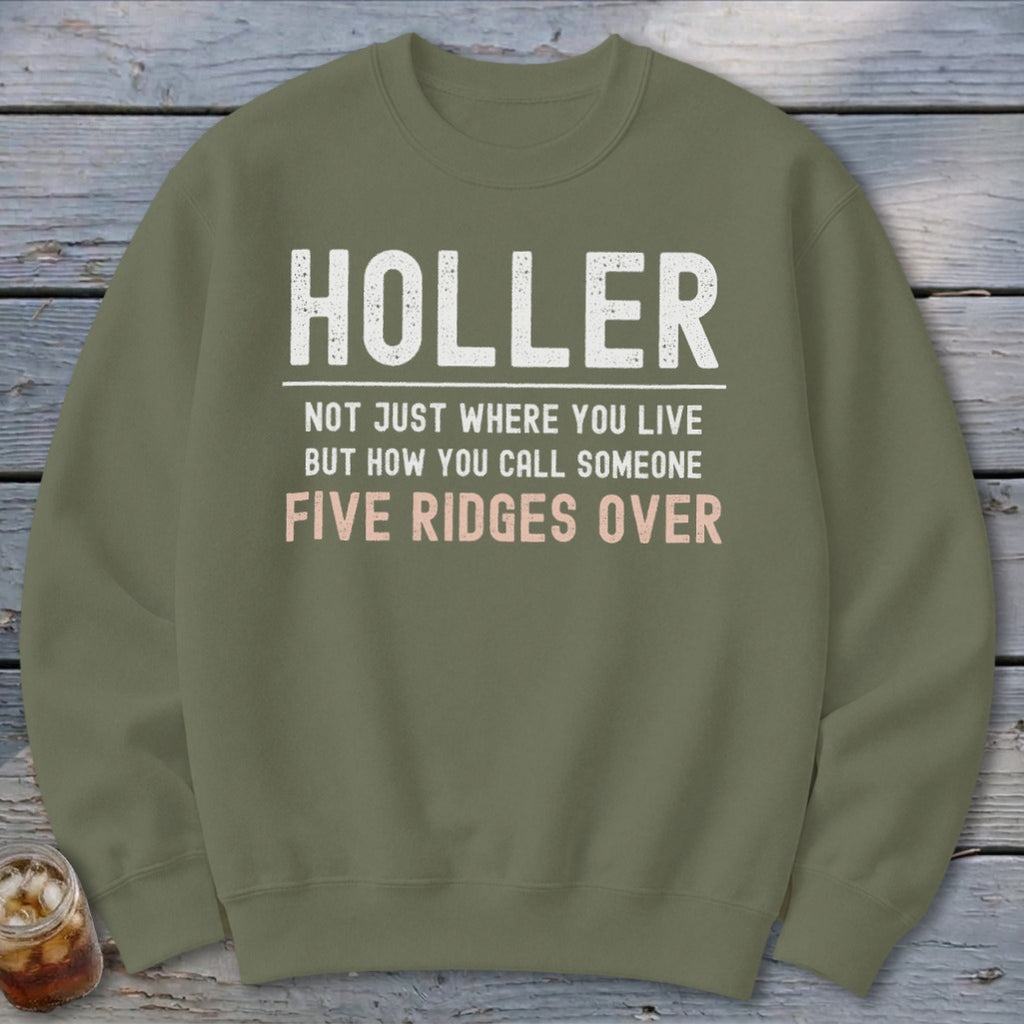 Olive green sweatshirt with text "HOLLER NOT JUST WHERE YOU LIVE BUT HOW YOU CALL SOMEONE FIVE RIDGES OVER".