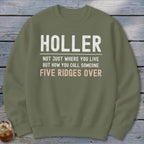 Olive green sweatshirt with text "HOLLER NOT JUST WHERE YOU LIVE BUT HOW YOU CALL SOMEONE FIVE RIDGES OVER".