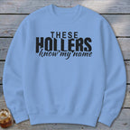 Light blue crewneck sweatshirt with black text reading "THESE HOLLERS know my name."