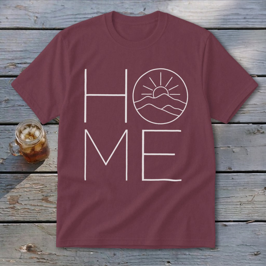 Maroon crewneck t-shirt with a white graphic spelling HOME, featuring mountains and a sun inside the letter O.