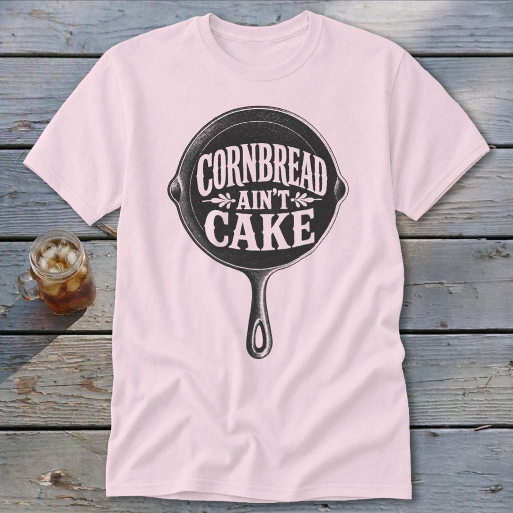 Pink t-shirt with cast iron skillet graphic and text "Cornbread Ain't Cake".