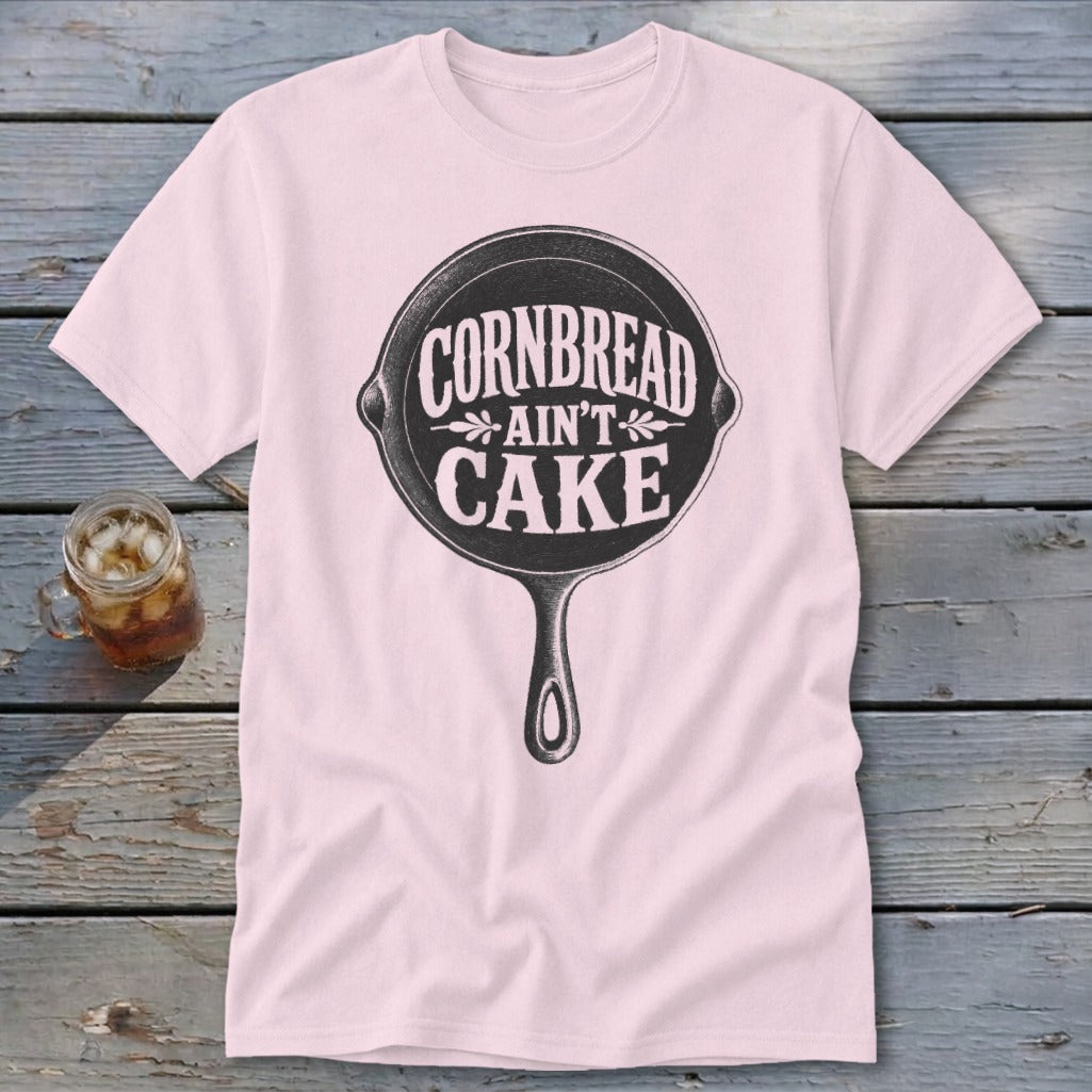 Pink t-shirt with cast iron skillet graphic and text "Cornbread Ain't Cake".