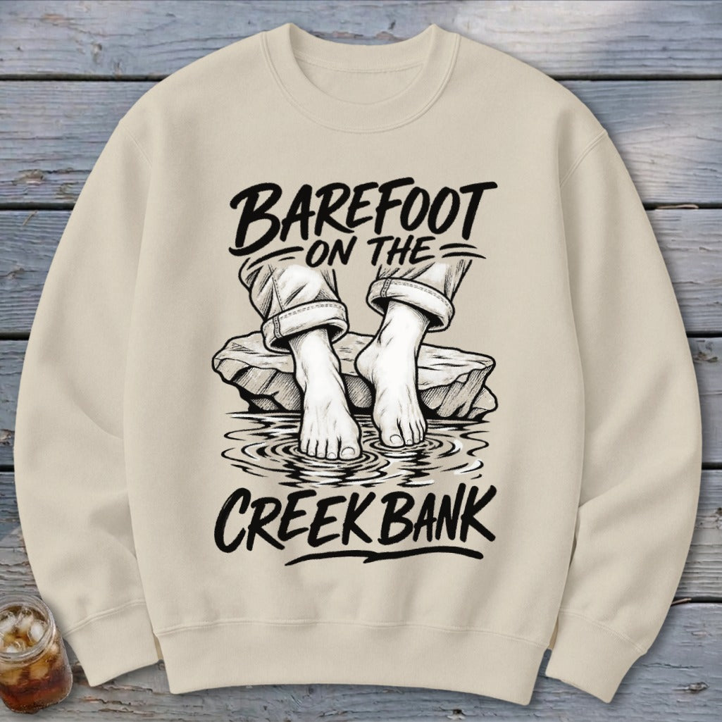 Crewneck sweatshirt with "Barefoot on the Creek Bank" text and illustration.
