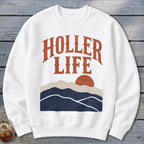 A white crewneck sweatshirt featuring the text HOLLER LIFE above a sunset landscape graphic.