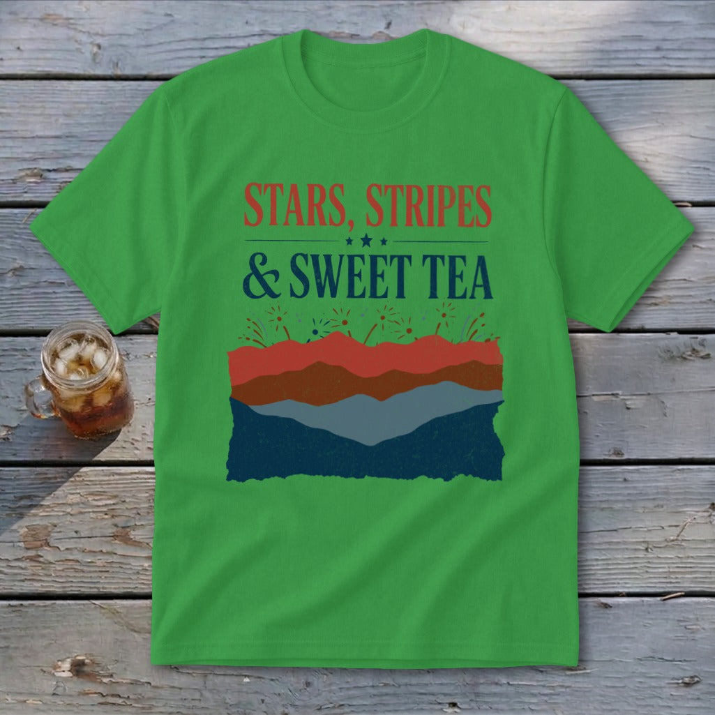 A green t-shirt featuring the text "Stars, Stripes & Sweet Tea" and a layered mountain landscape graphic.