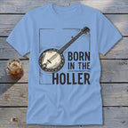 Light blue t-shirt with banjo graphic and text "BORN IN THE HOLLER".