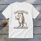 White t-shirt with opossum holding coffee, "Don't Mind Me, I'm Just Sulled Up".