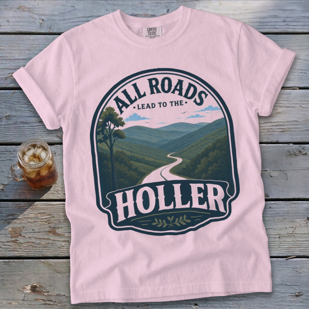 Pink t-shirt with "All Roads Lead to the Holler" graphic featuring a winding road through mountains