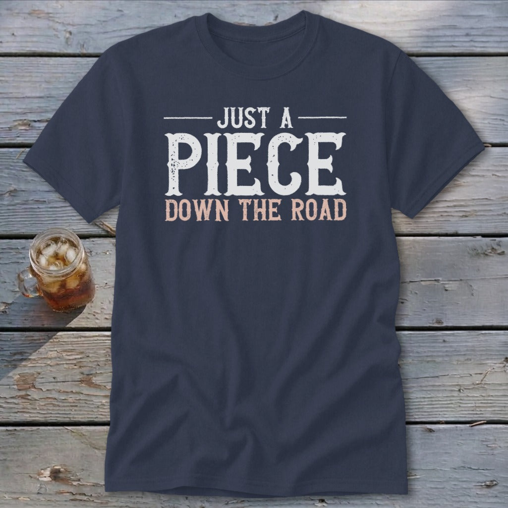 Navy t-shirt with text "JUST A PIECE DOWN THE ROAD" in white and pink.